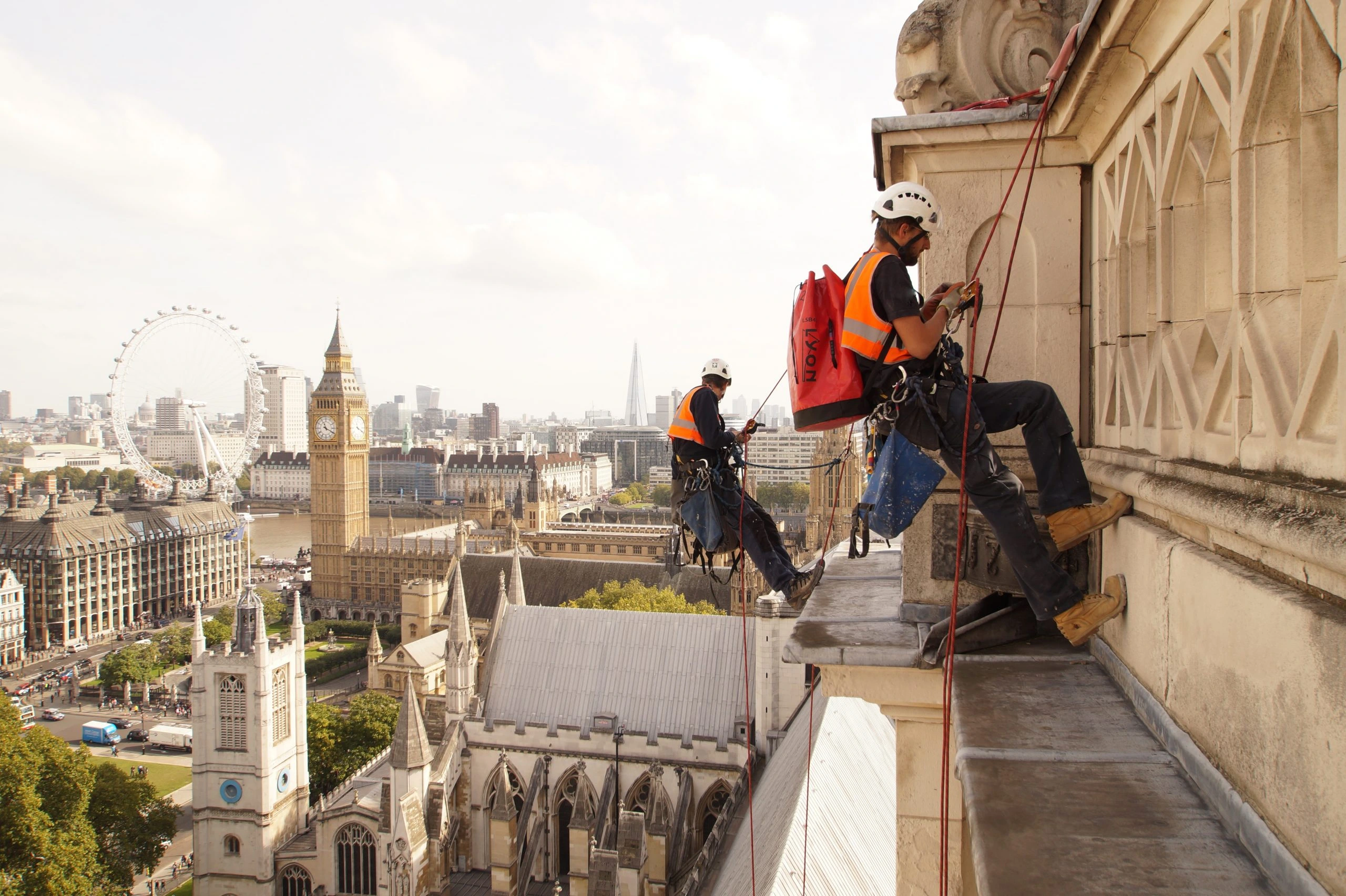 Rope Access Abseil Inspection London Rope access technicians abseil to inspect a high rise building in London assessing structural condition and safety