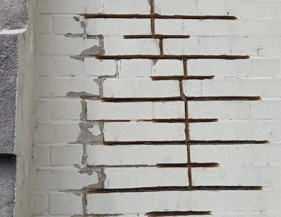 Rope Access Brick Stitching Repairs – Structural Crack Stabilization Rope access technicians performing brick stitching repairs to stabilize cracks in a high-rise building facade, ensuring long-term structural integrity.