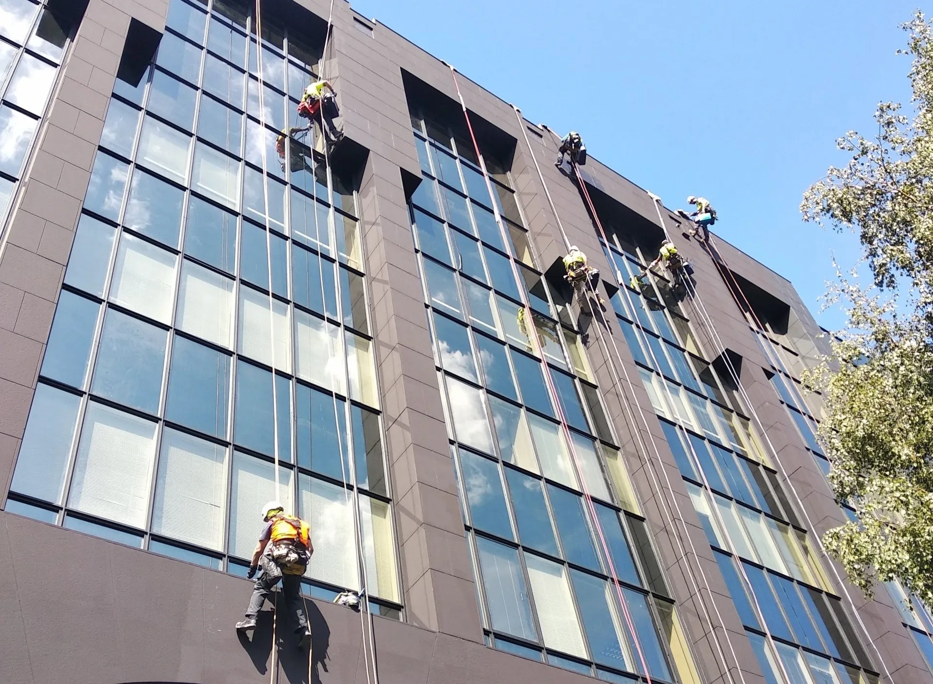 Rope Access Commercial Painting London Rope access technicians performing commercial painting on a high rise building in London to maintain and protect exterior surfaces
