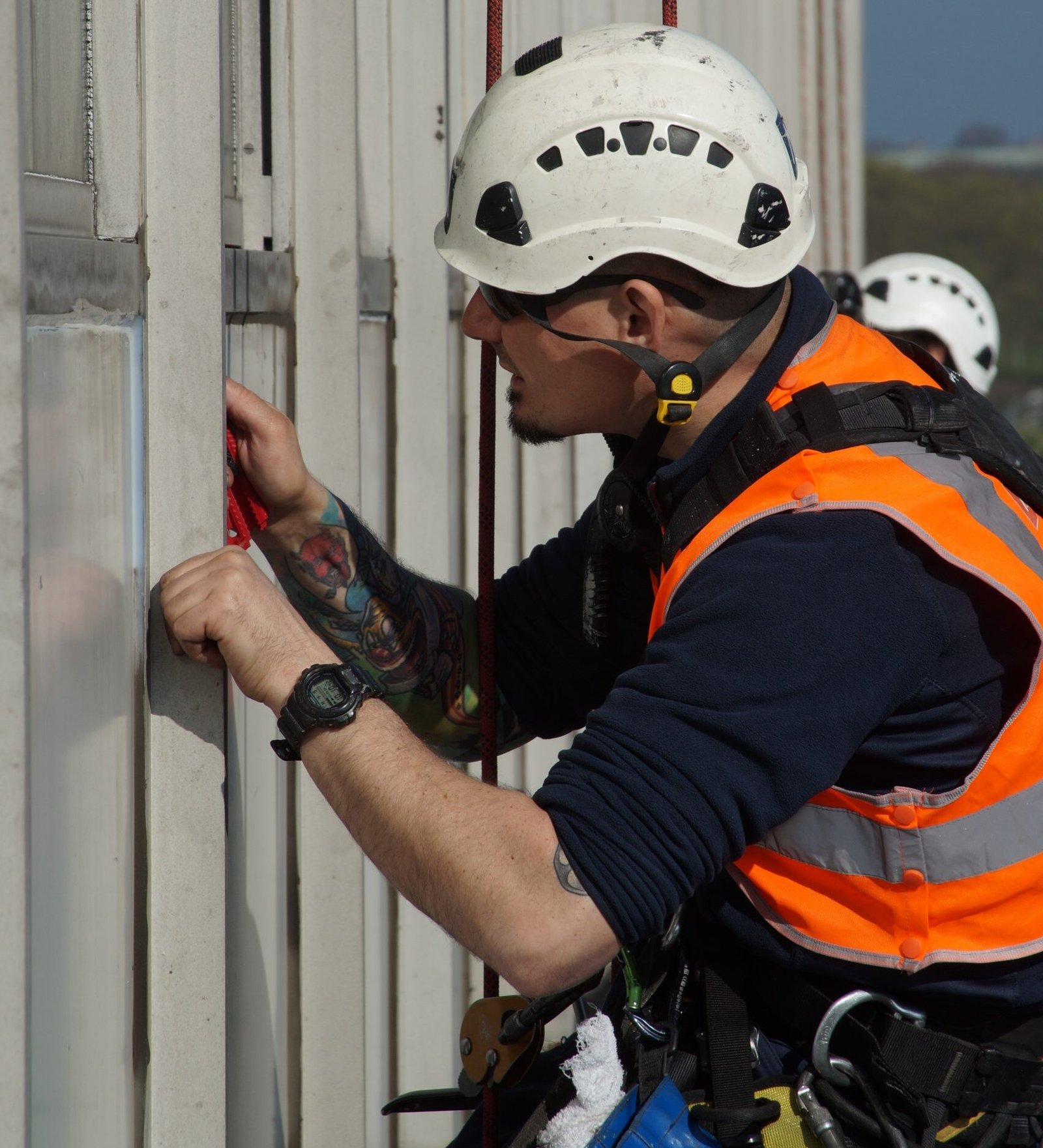 Rope access technicians carrying out building maintenance sealant works on a high rise in London to protect against water ingress and weather damage